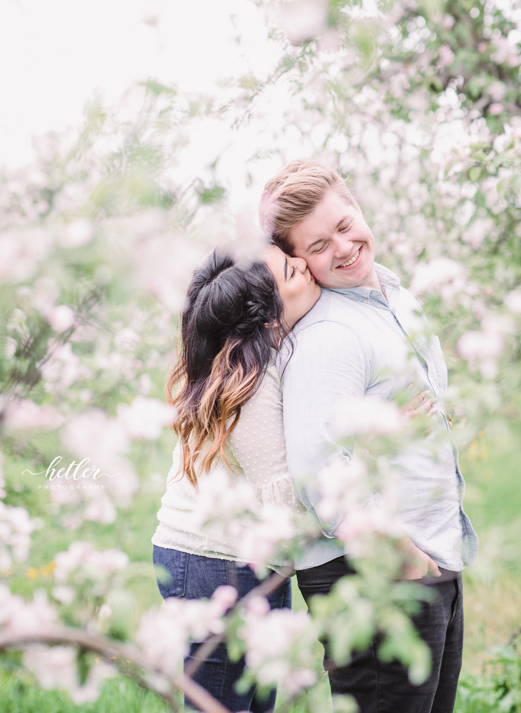 Grand Rapids spring engagement photos in apple blossoms Res Life worship team