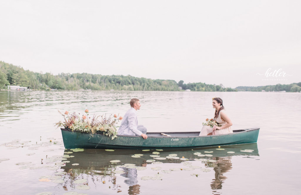 Northern MIchigan lakeside wedding inspiration boho picnic theme in a canoe