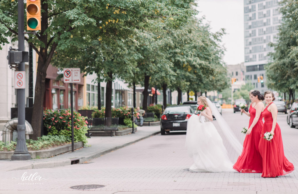 Downtown Grand Rapids CityFlats wedding with bridesmaids in red