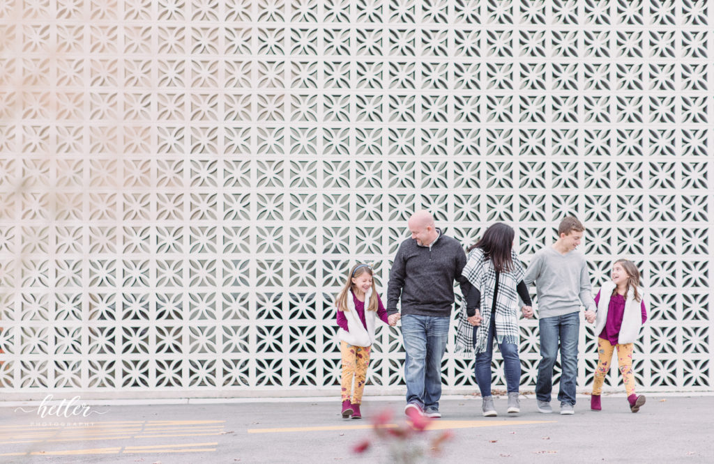 Downtown Grand Rapids fall family photos in the city in front of the white breeze block wall