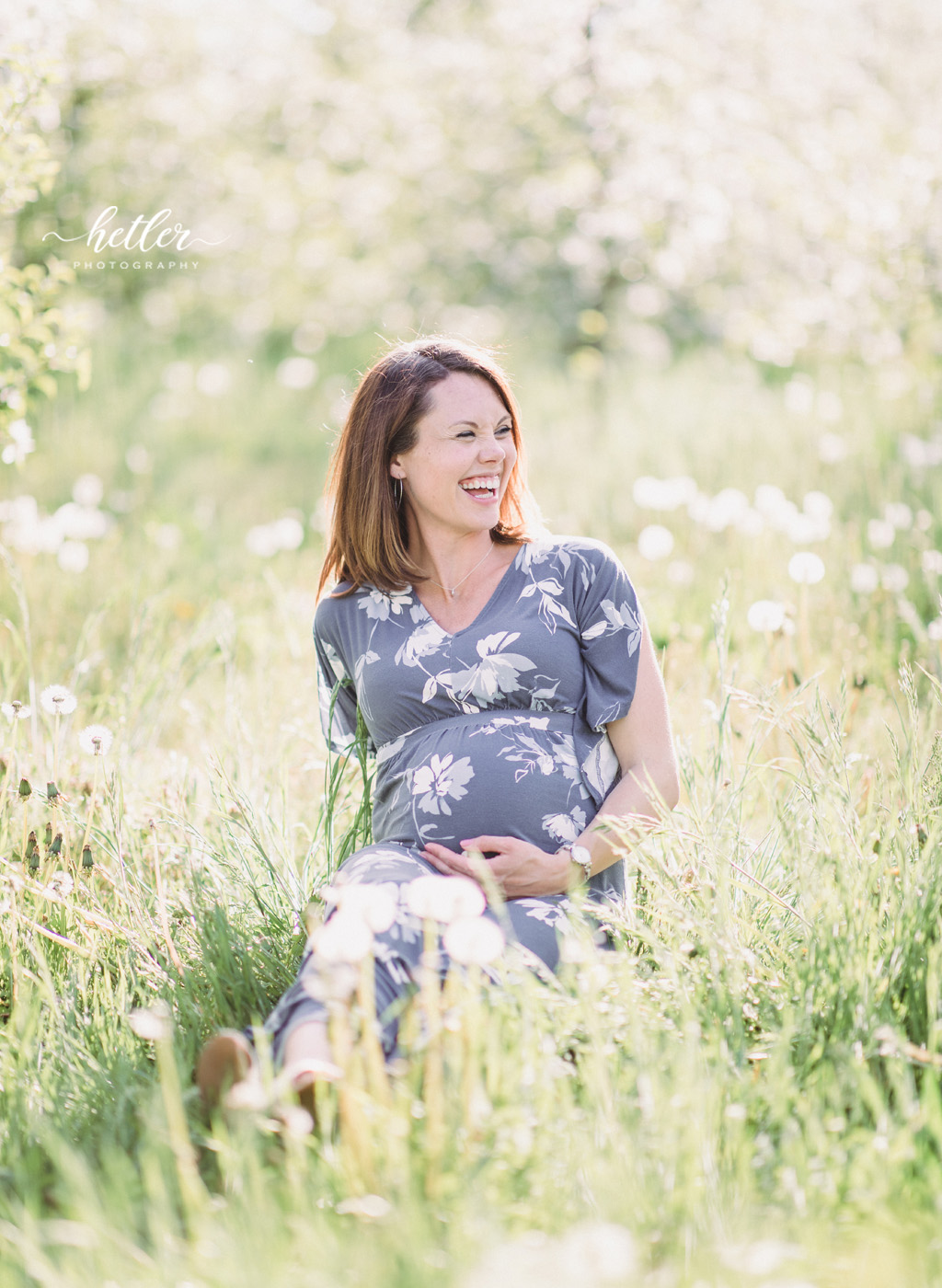 Grand Rapids maternity photos with a rainbow baby in apple blossoms