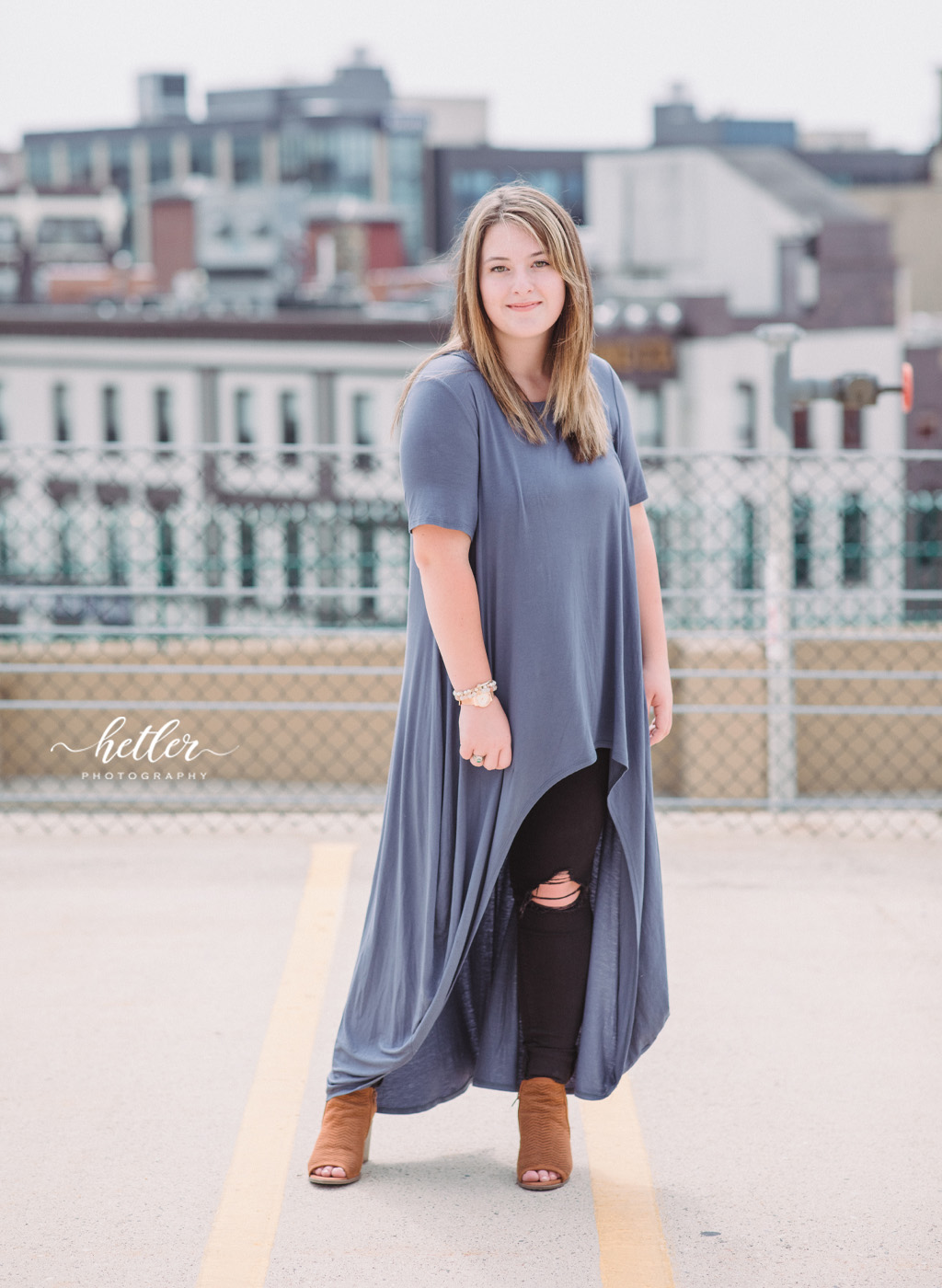 downtown Grand Rapids senior photos with a high school senior girl in a felt hat, ripped black jeans and trendy outfit