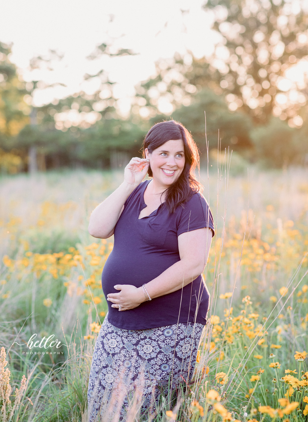 Fremont Michigan maternity photos in a field of wildflowers