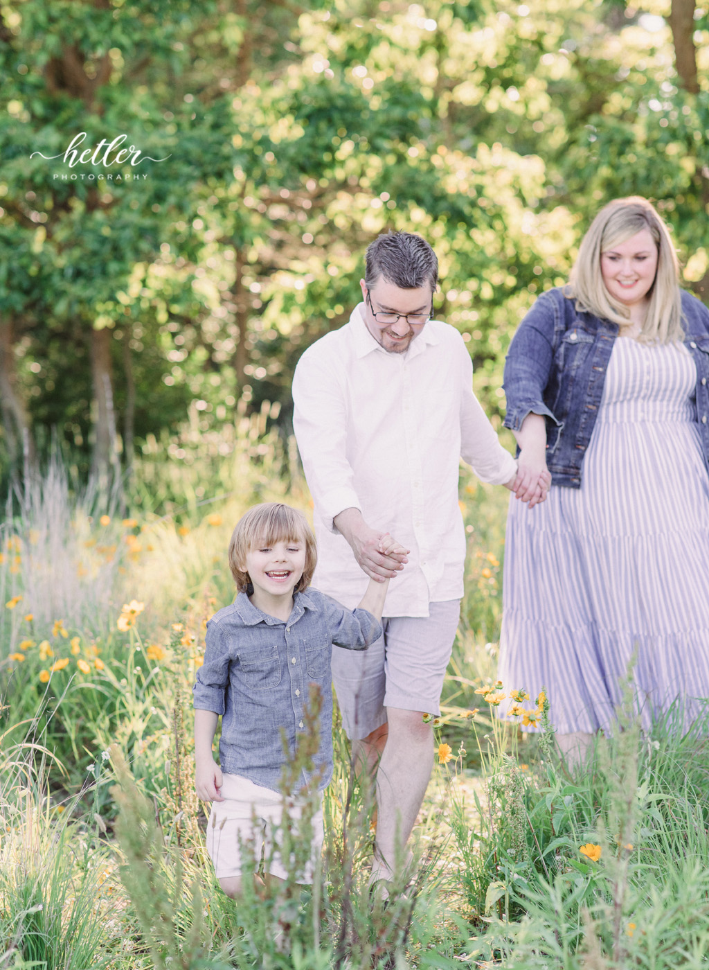 Fremont Michigan family photos in a field of yellow wildflowers