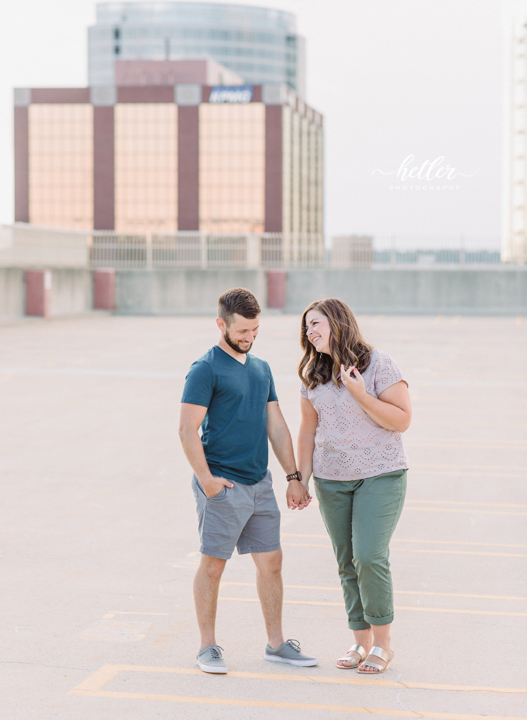 Downtown Grand Rapids family pics on a parking garage rooftop with views of the city and with a white breeze block wall