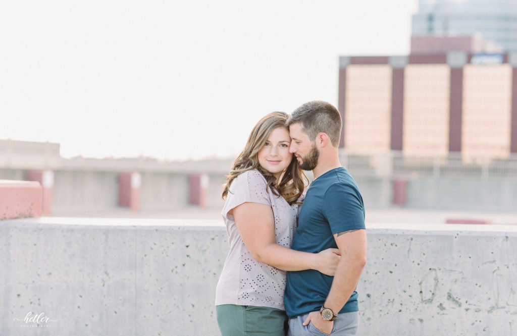 Downtown Grand Rapids family pics on a parking garage rooftop with views of the city and with a white breeze block wall
