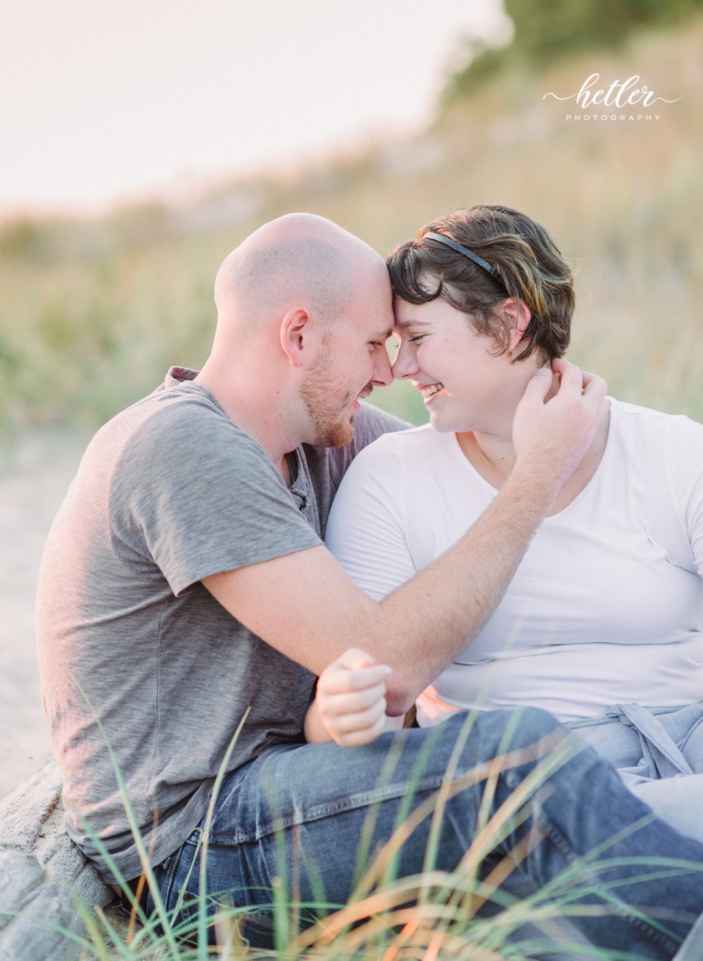Muskegon beach engagement photos at PJ Hoffmaster park on a hot summer night with a soft and colorful sunset