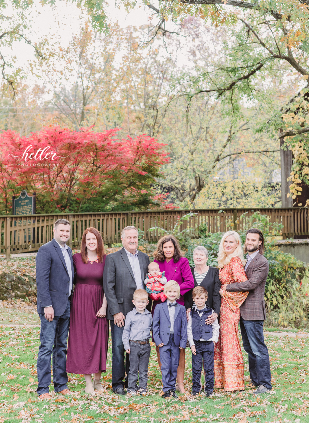 Extended family photos in the fall at the Ada covered bridge