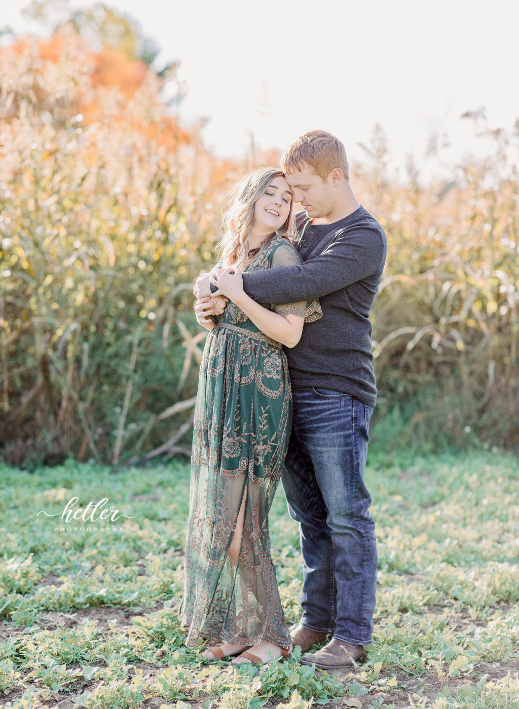 Grand Rapids fall engagement photo session with golden hour light at a lake and country location