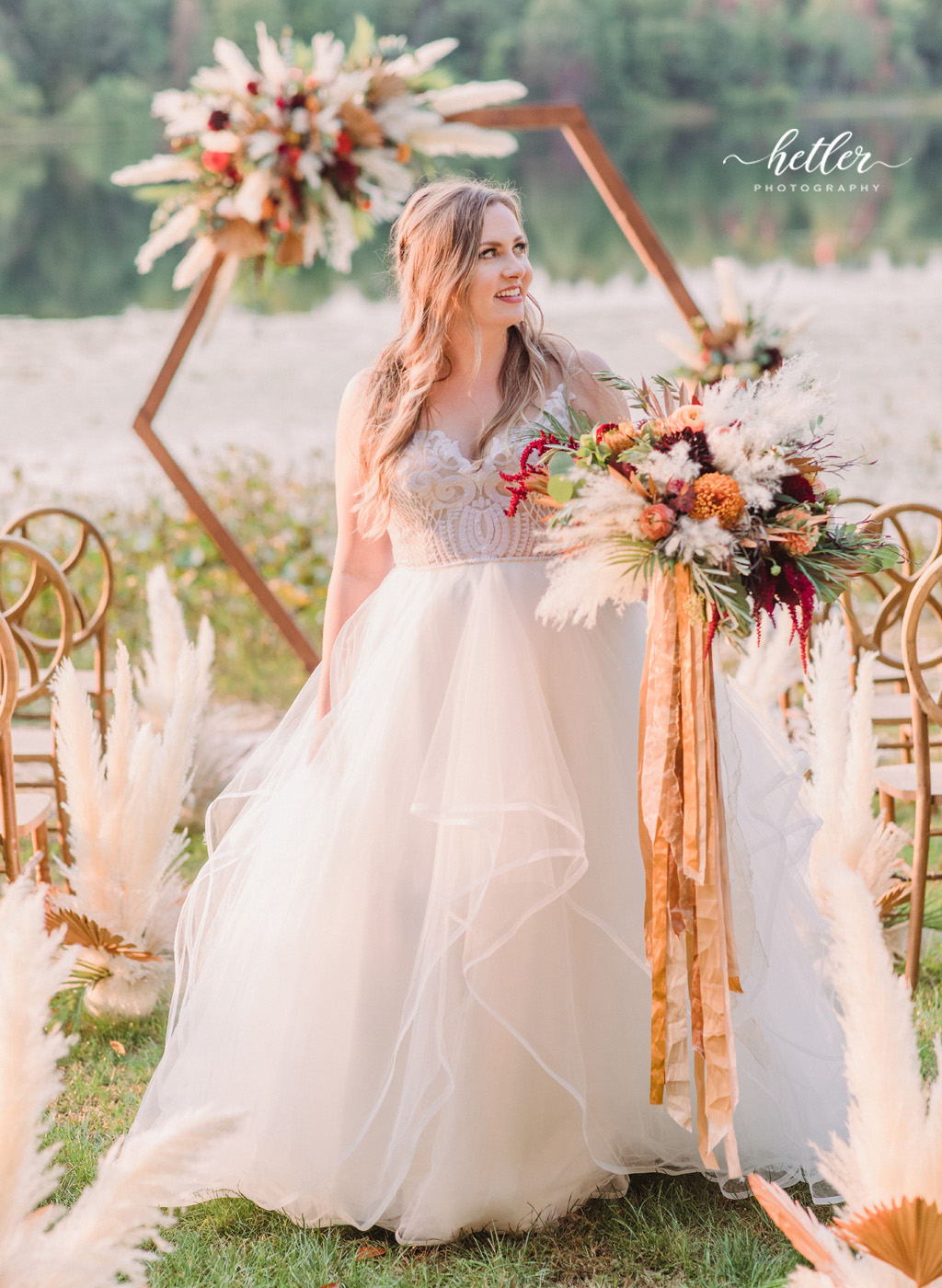 Bride in Hayley Paige gown from Becker's Bridal at lakeside wedding
