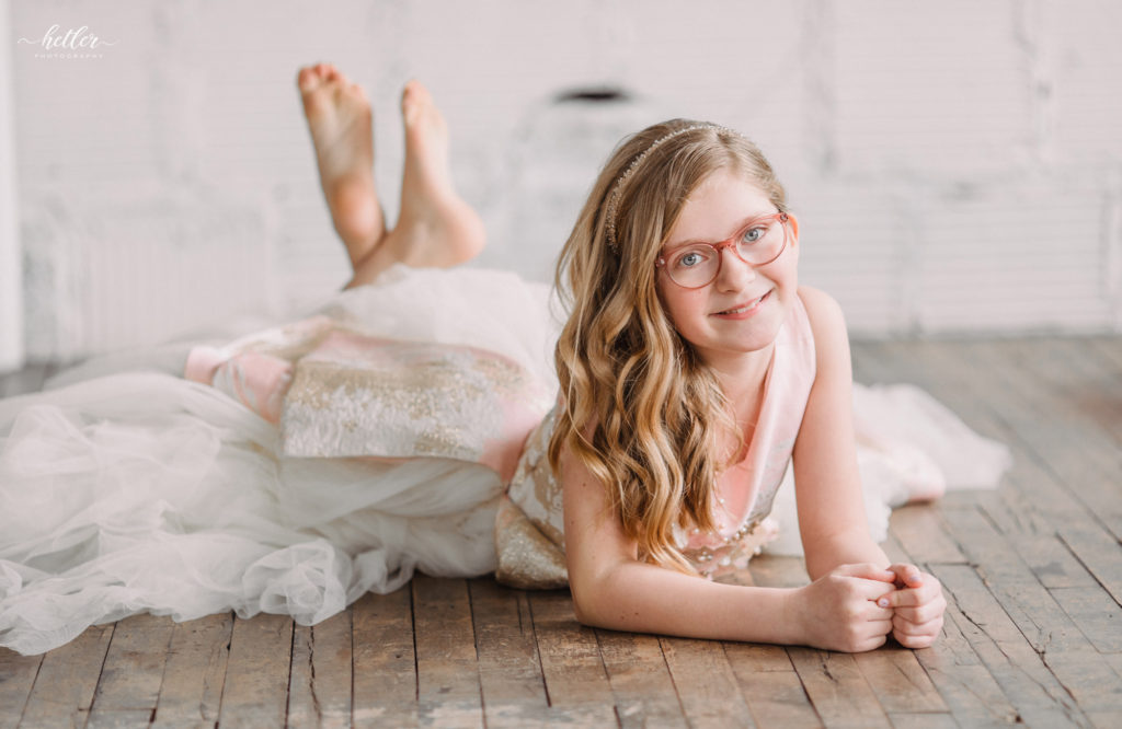 Grand Rapids studio photo session for a tween girl in a rented Soapbox Kids dress from Rainey's Closet