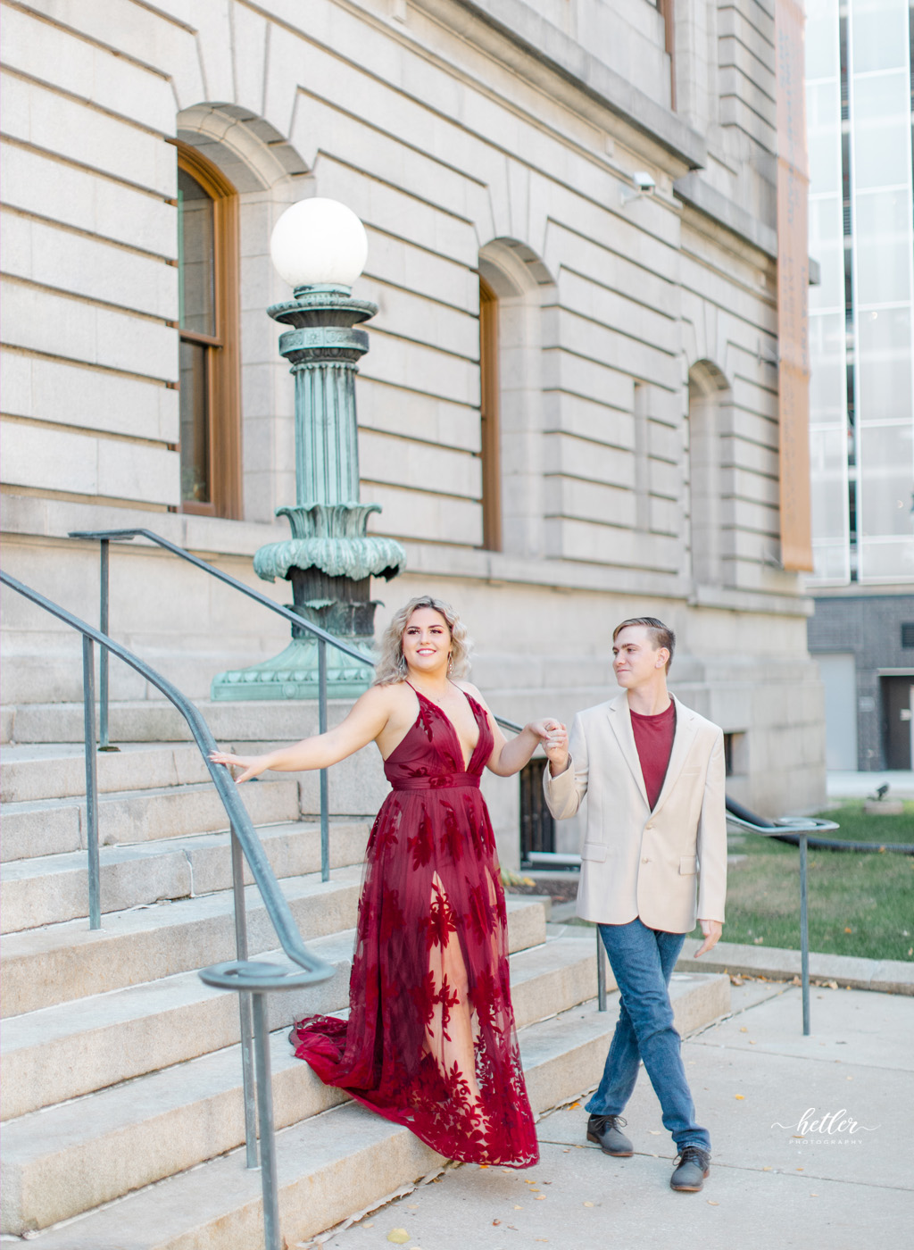 Grand Rapids Michigan engagement photos in downtown with a bride to be in a stunning red dress