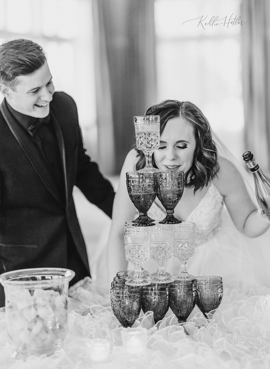 bride and groom with champagne tower at wedding reception