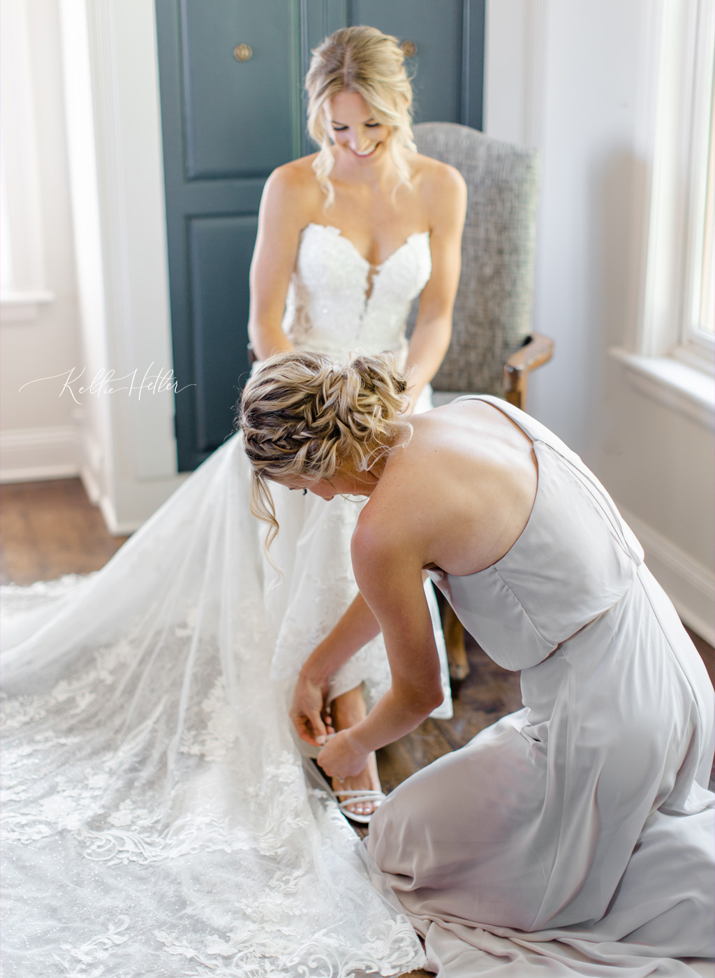 maid of honor putting on bride's shoe