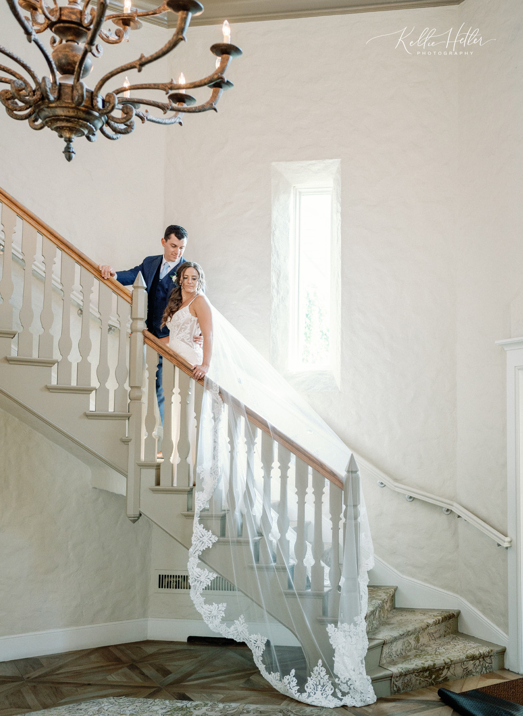 bride and groom on stairs in cascade hills country club